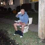 Guy on toilet reading book drinking coffee