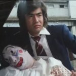 Hiroshi Fujioka holding a dead clown