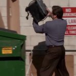 Man throwing computer in trash