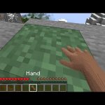 Hand touching Minecraft grass block
