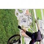 Man Falling Off Bike Mid-Air