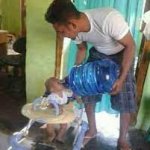 guy feeds baby water keg
