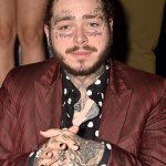 Post Malone suit rubbing hands together