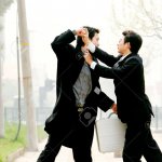 Two Men In Business Suits Fighting