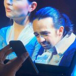 Lin Manuel Miranda reading a phone