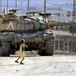 Palestinian child throwing a rock at an Israeli tank