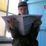 Russian Soldier reading Obituaries.