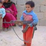 Little Indian kid holding gun