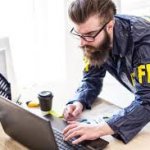 FBI agent on laptop computer