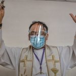 Priest wearing mask