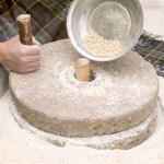 Close up of a hand-powered stone grist mill