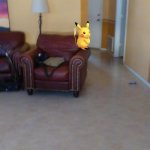 A Pikachu on the edge of a chair