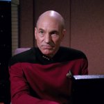 PICARD LOOKS UP FROM THE MONITOR ANGRILY