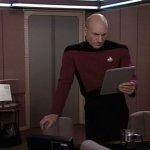 PICARD LOOKING AT A TABLET