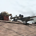 Sniper on roof crest