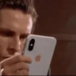 Patrick Bateman looks at phone then drops it meme