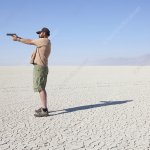 Guy with Gun In The Desert
