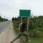 Guy running in front of sign