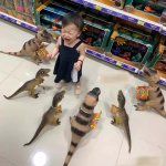 Child surrounded by dinosaurs