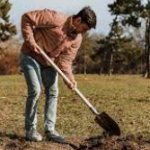 man with shovel digging
