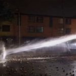 Protester withstanding Hose