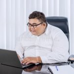 Fat businessman laptop computer asian glasses