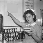 OLD-TIME DINER, WAITRESS, POINTING AT SIGN