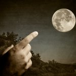 finger pointing to the moon