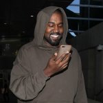 kanye smiling at phone