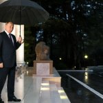 Vladimir Putin with black umbrella