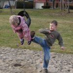 Boy kicking sibling on swing jack and jill