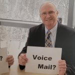 Old man holding an outdated sign pained smile