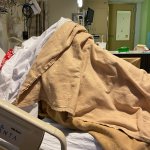 Patient hiding under blankets in hospital