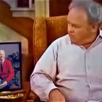 Archie looks at Biden/Mr Rogers picture