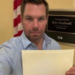 eric swalwell with blank sign