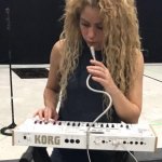 Shakira playing synth