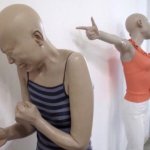 Mannequin pointing at crying mannequin