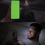 random guy in bed at night looking at phone