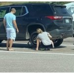 woman changing tire
