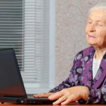ELDER WOMAN WITH PC