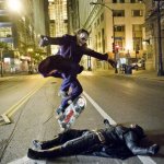 joker skateboarding over bat man
