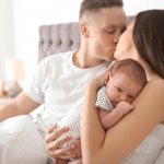 Happy normal couple with a baby