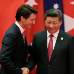Justin Trudeau smiling at Xi Jinping