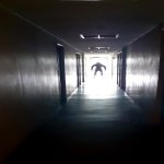 Dark man in dark corridor