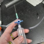 hand holding syringe with large needle