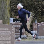 Old guy jogging in cemetery