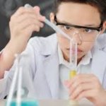 Young male science nerd doing science with test tube