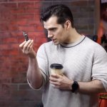 henry cavill examining warhammer figurine