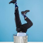 man upside down in garbage can