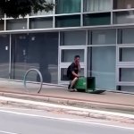 Man Riding Trash Can